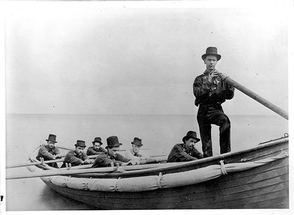 Group photograph taken in 1875 of the student rescue crew and surfboat. (Courtesy of the NWU Deering Library) Group photograph taken in 1875 of the student rescue crew and surfboat. (Courtesy of the NWU Deering Library)